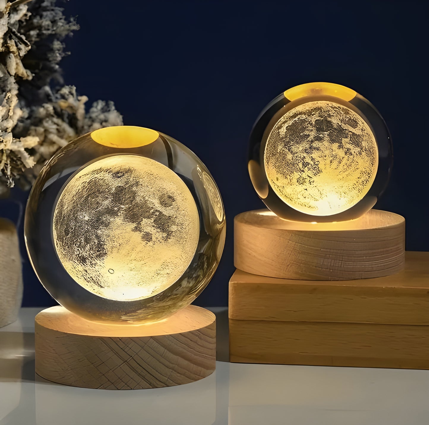 Two moon-shaped night lights on wooden bases with a dark blue background.