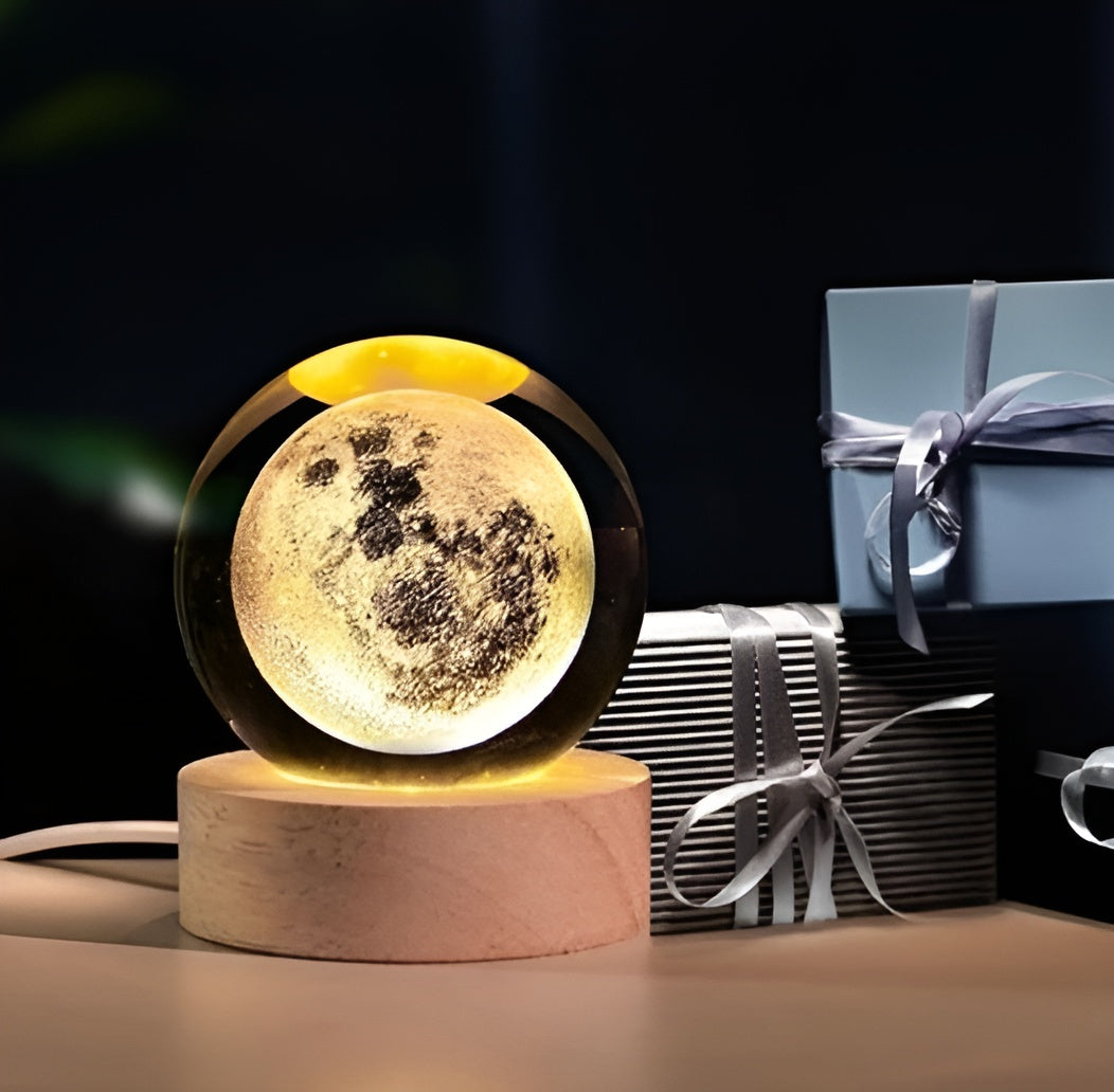 Glowing moon-shaped lamp on a wooden base with wrapped gifts in the background.