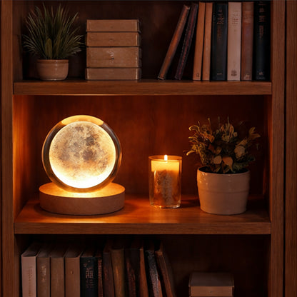 Moon lamp on a wooden shelf with books and plants